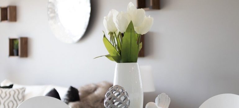 A white vase on the table.