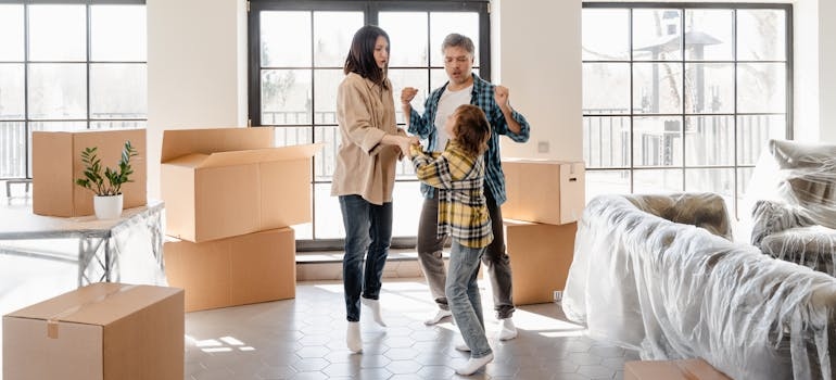 a Happy Family dancing amid boxes
