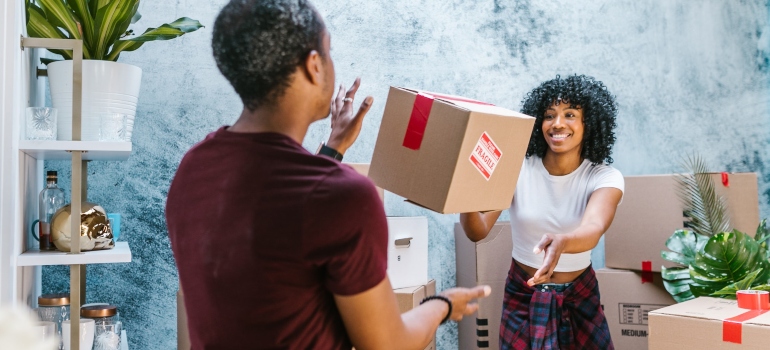 Two people packing and moving without disrupting your neighbors