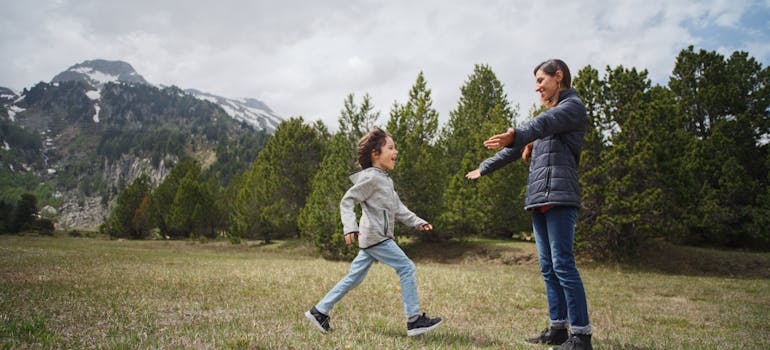 a child running towards a woman