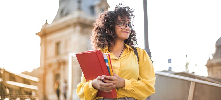 a student holding textbooks