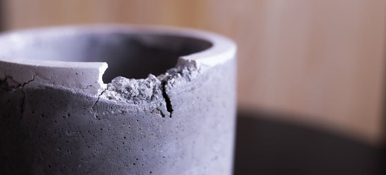 A chipped Gray Concrete Vase is one of the things to get rid of before moving
