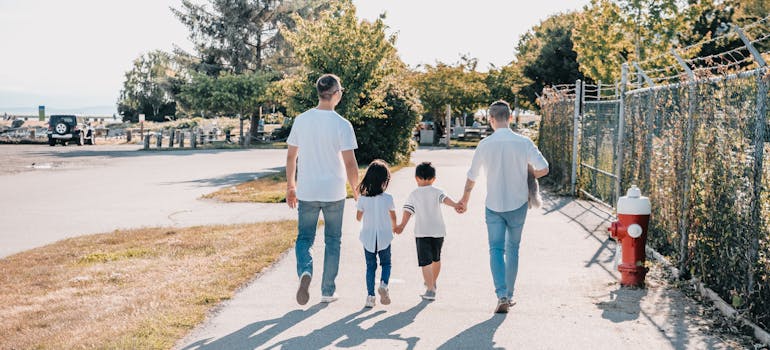 back view of happy family holding hands, looking into best Idaho cities for families