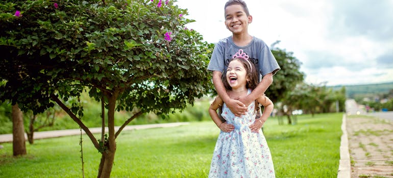 a boy and a girl smiling and thinking about best Idaho cities for families
