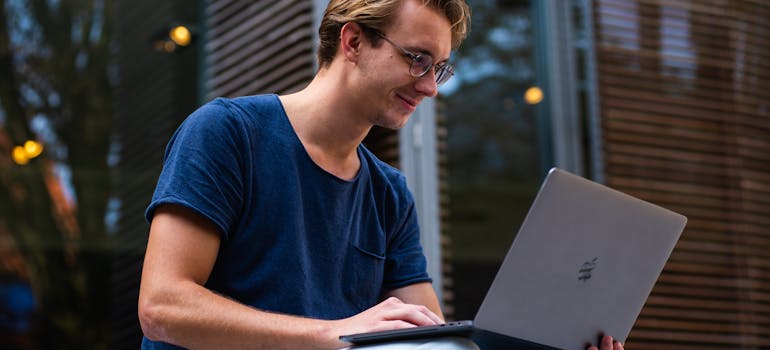 a student doing research on his laptop